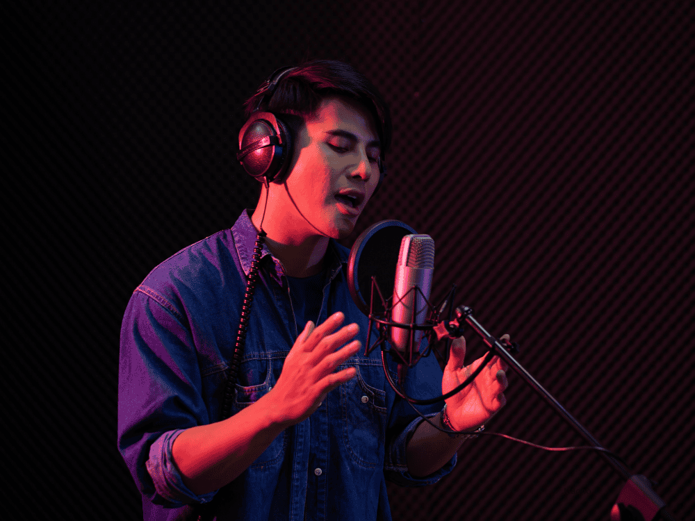A man singing vocals using an XLR mic